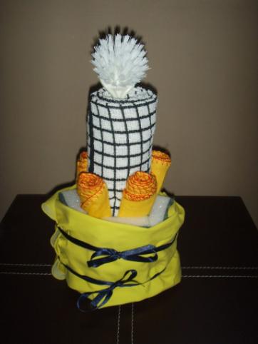 CLEANING CAKE - £8.00 5 dusters, 1 tea towel, 5 scourers, 1 pair rubber gloves, 1 dish brush.
